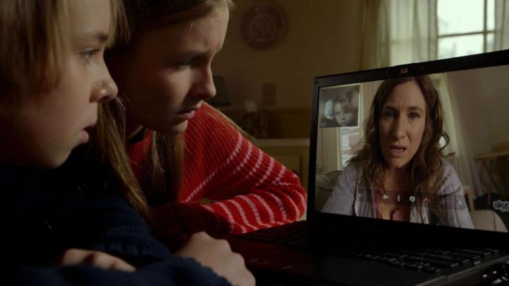 Two children talking to a woman via Zoom in the movie The Visit.