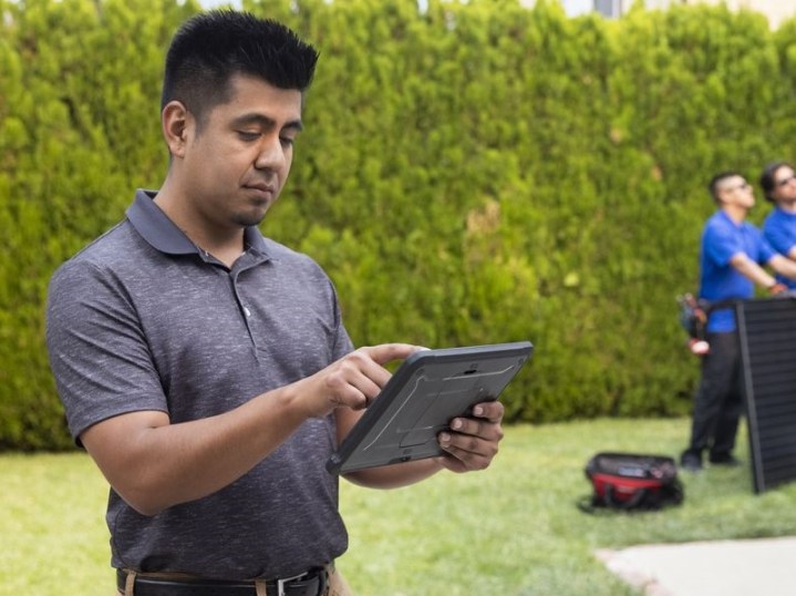 Man working on tablet using Intuit QuickBooks Online