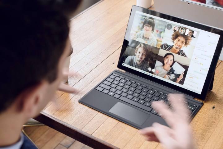 A person conducting a video call on a Microsoft Surface device running Windows 11.