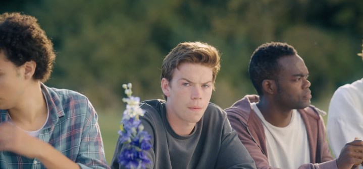 Mark sitting at a dining table in "Midsommar."