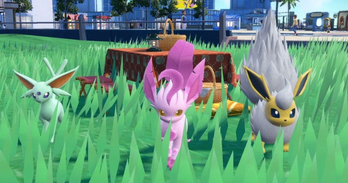 Three shiny Pokemon next to a picnic.