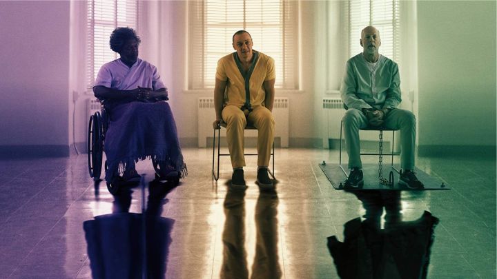 Three men sitting in chairs under different lighting in the movie Glass.