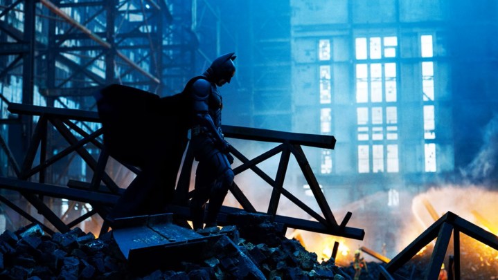 Batman brooding over a wreckage in The Dark Knight.