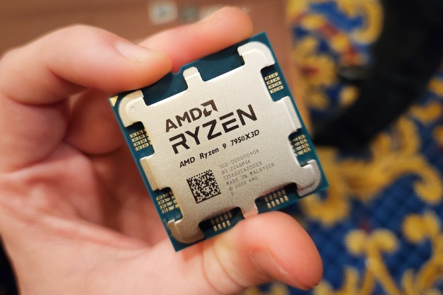 A hand holding AMD's Ryzen 9 7950X3D processor.