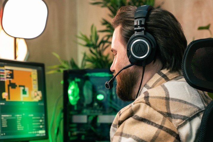 A streamer wearing the Audio-Technica M50xSTS headset.