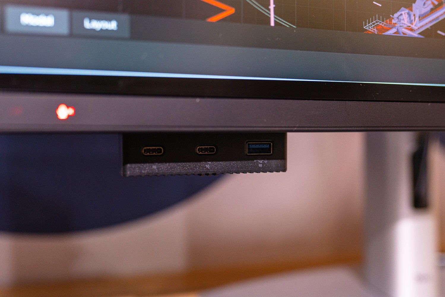The flip-down ports under the Dell UltraSharp 6K monitor.
