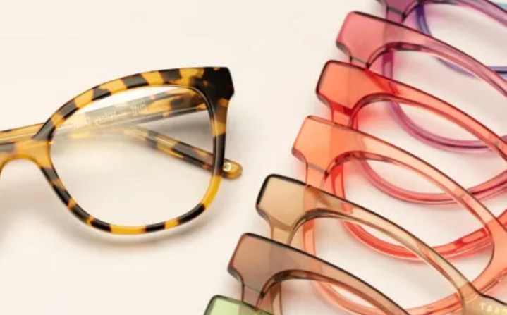 Multi-colored glasses lined up on an ivory background.