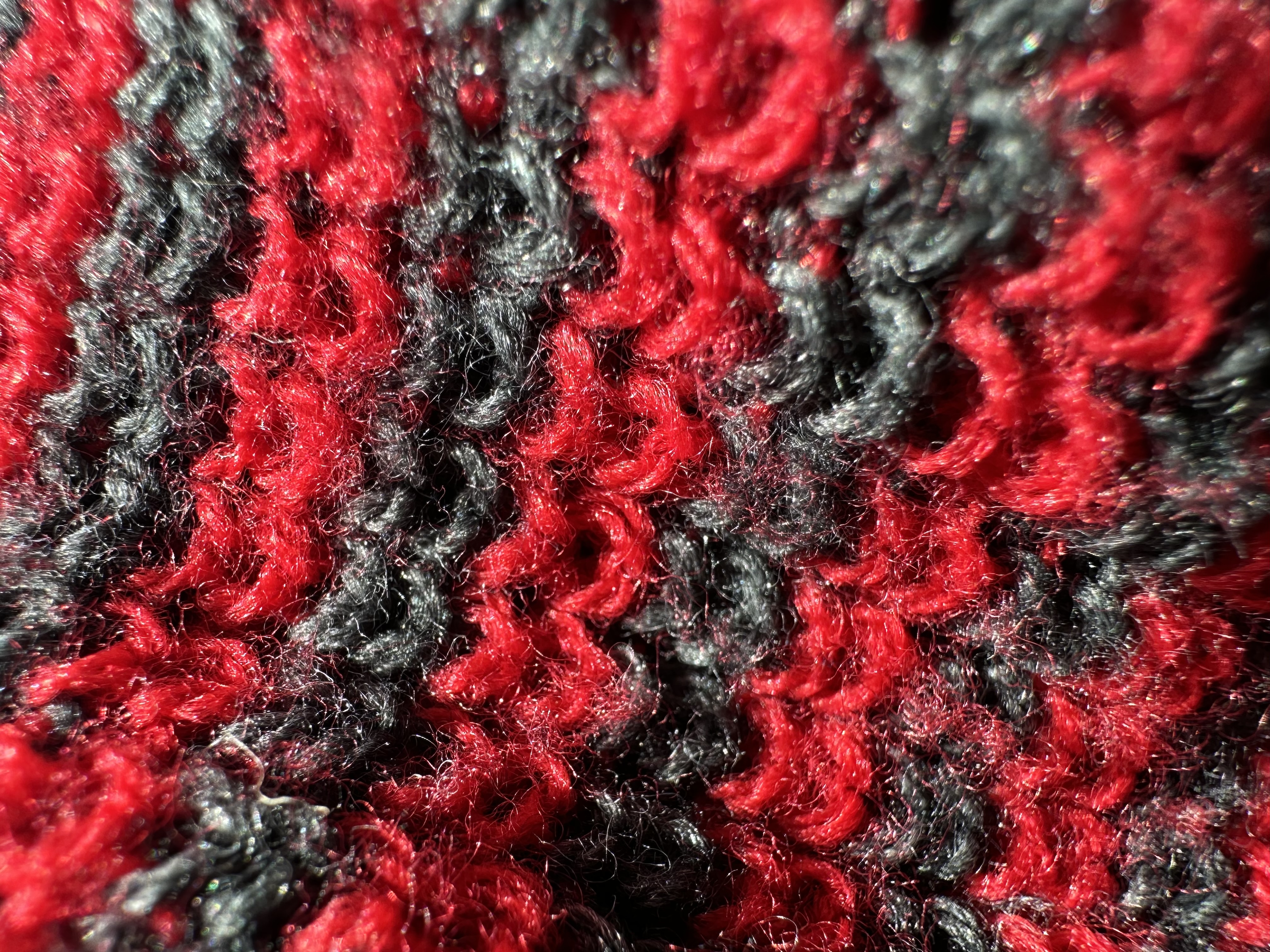 Macro photo of a red and black beanie.
