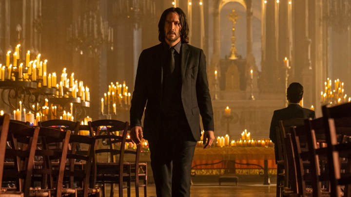 Keanu Reeves stands in a church in John Wick: Chapter 4.