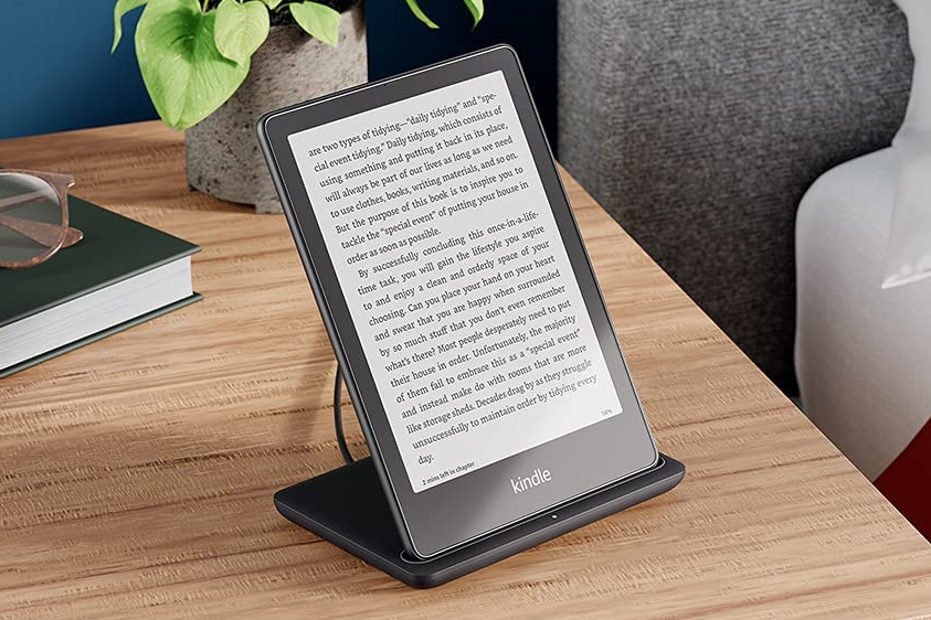 A Kindle paperwhite signature edition in its dock.