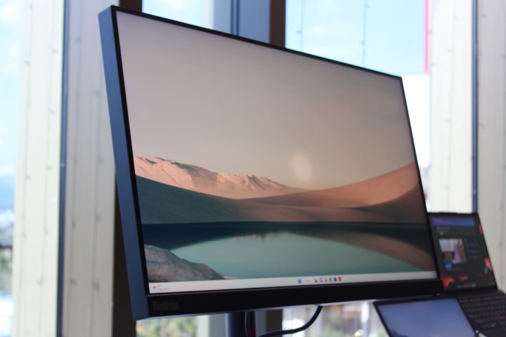 Lenovo's ThinkVision Mini-LED monitor in front of a window.