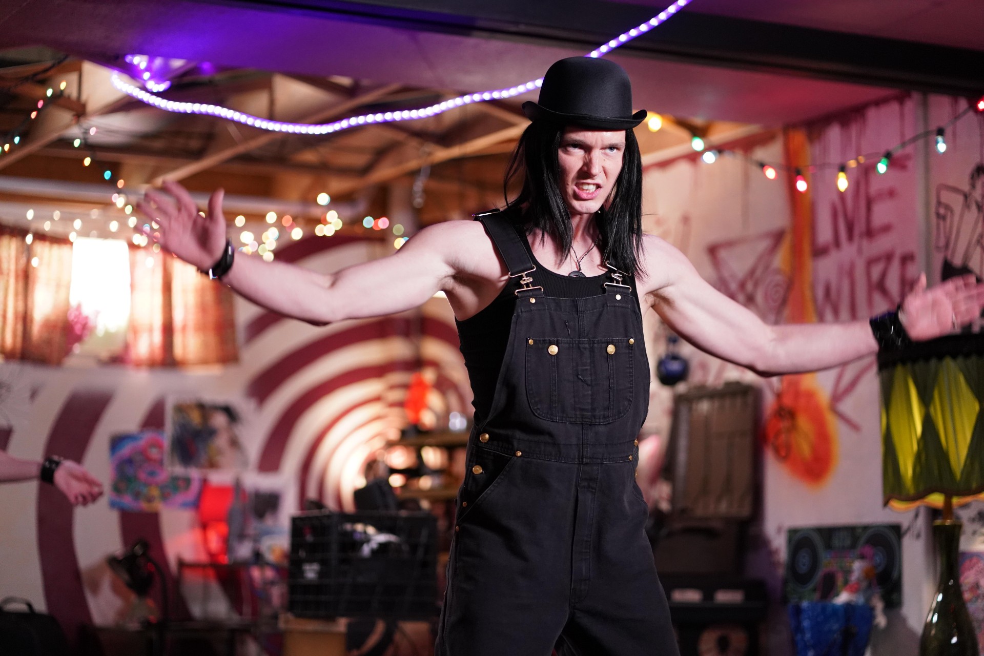 Tyler Johnston spreads his arms wide in a scene from Letterkenny.