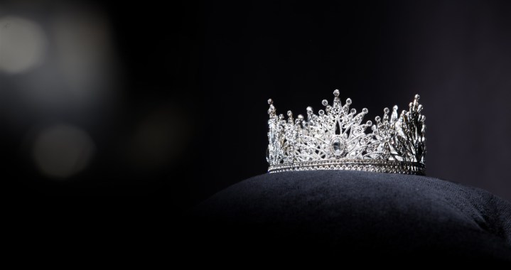 A diamond crown rests on a pillow.