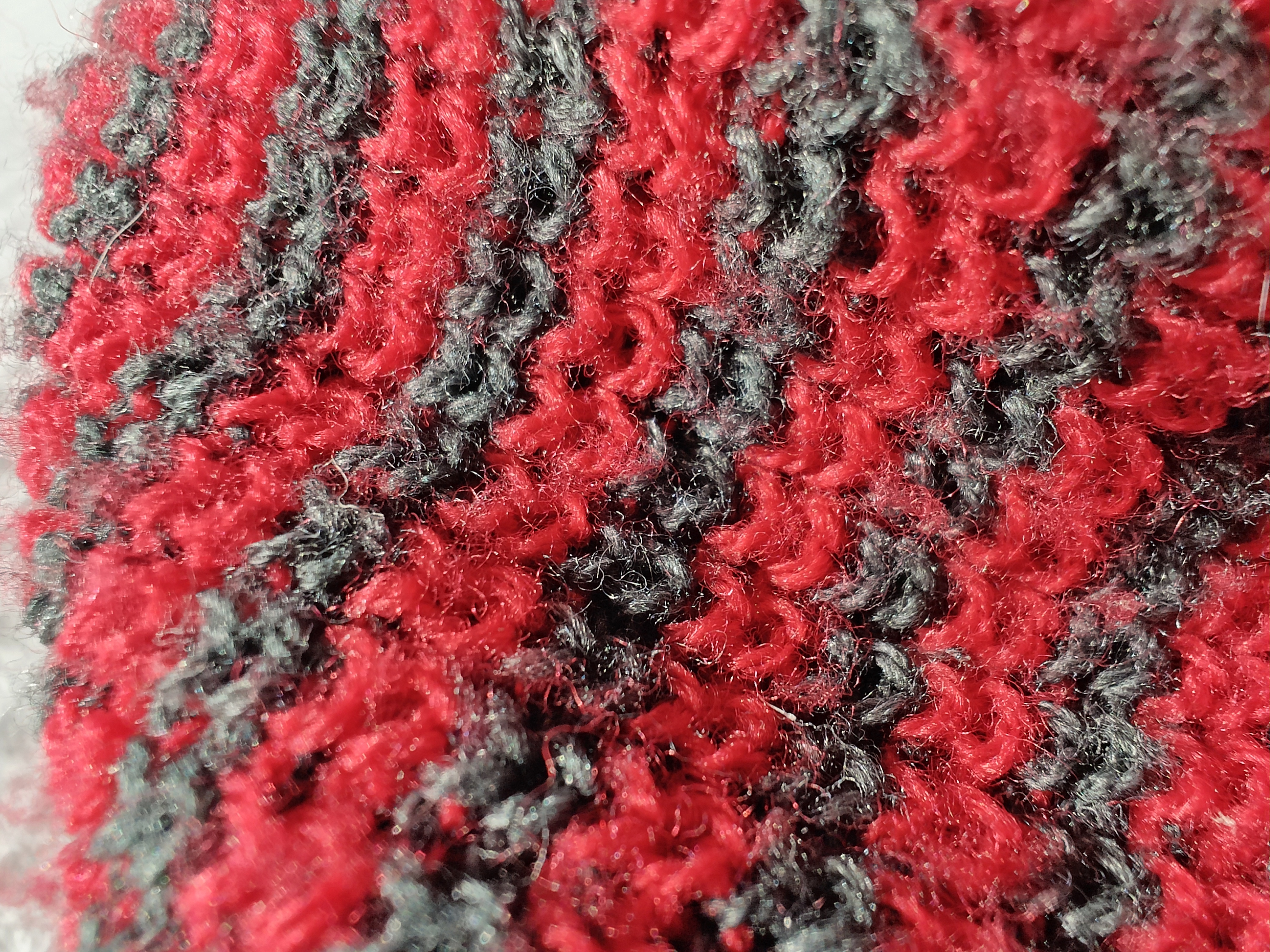 Macro photo of a red and black beanie.