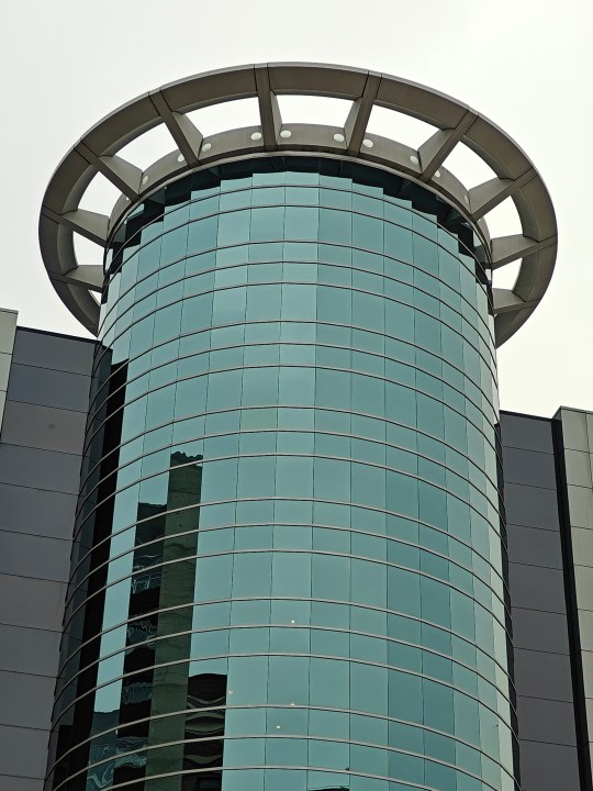 Zoomed in photo of a circular, glass building.