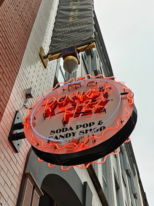 Photo of a neon sign for a soda shop.