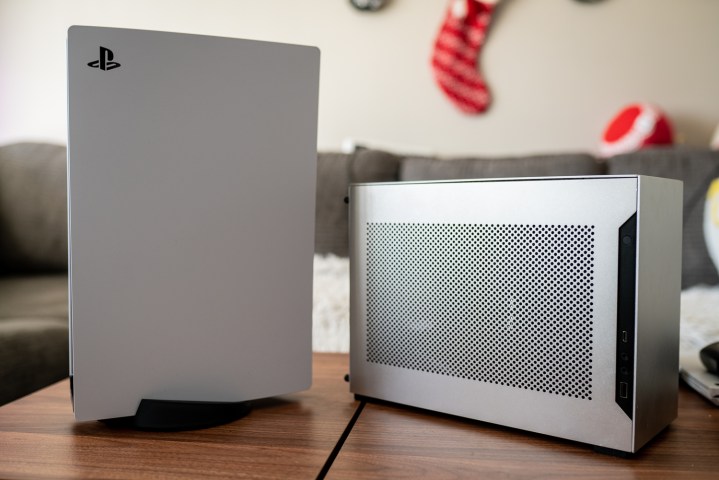 A small gaming PC sitting next to the PS5.