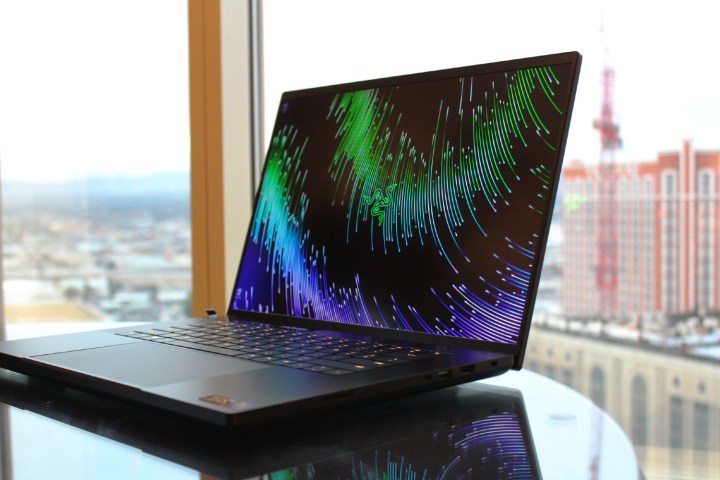 The Razer Blade 18 on a table in front of a window.