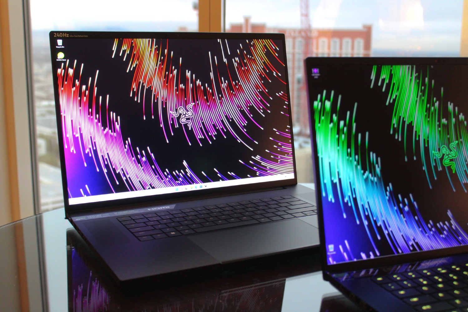 The Razer Blade 16 and 18 in front of a window.