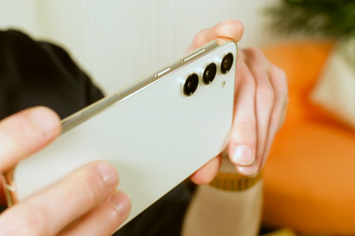 The back of the Samsung Galaxy S23 Plus. Someone is holding it to take photos.