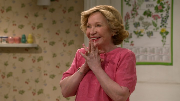 Kitty Foreman smiling, her hands to her face in a scene from That '90s Show.
