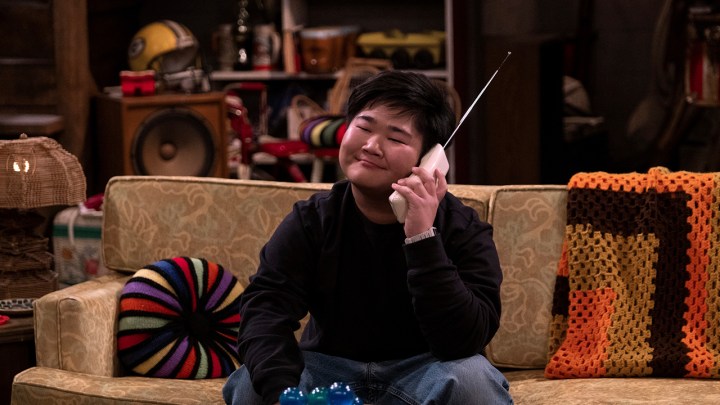 Оззи из шоу 90-х улыбается, разговаривая по беспроводному телефону.