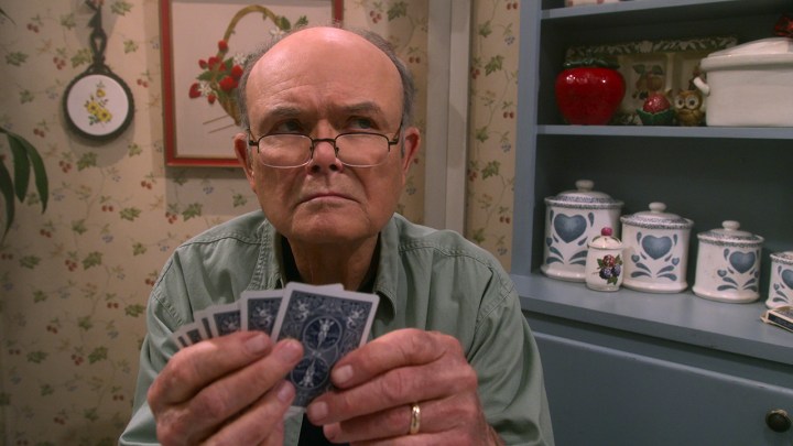 Red Foreman playing cards and looking angry in a scene from That '90s Show.