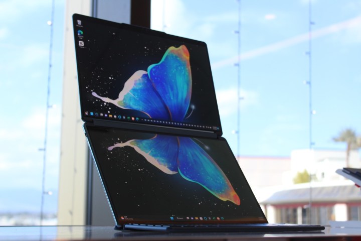 The two displays of the Yoga Book 9i on a table.