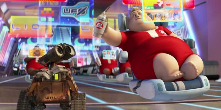 A fat man tries to hand a cup to a robot in Wall-E.