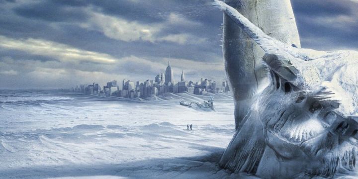 A frozen statue of liberty stands in front of New York City in The Day After Tomorrow.