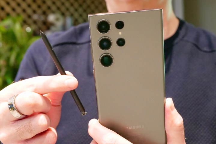 The Samsung Galaxy S23 Ultra with the S Pen held in a person's hand.