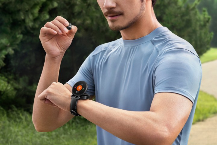 Person using the Huawei Watch Buds, with the smartwatch open on the wrist.