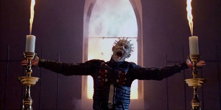 Pinhead laughs as he stands in a church.