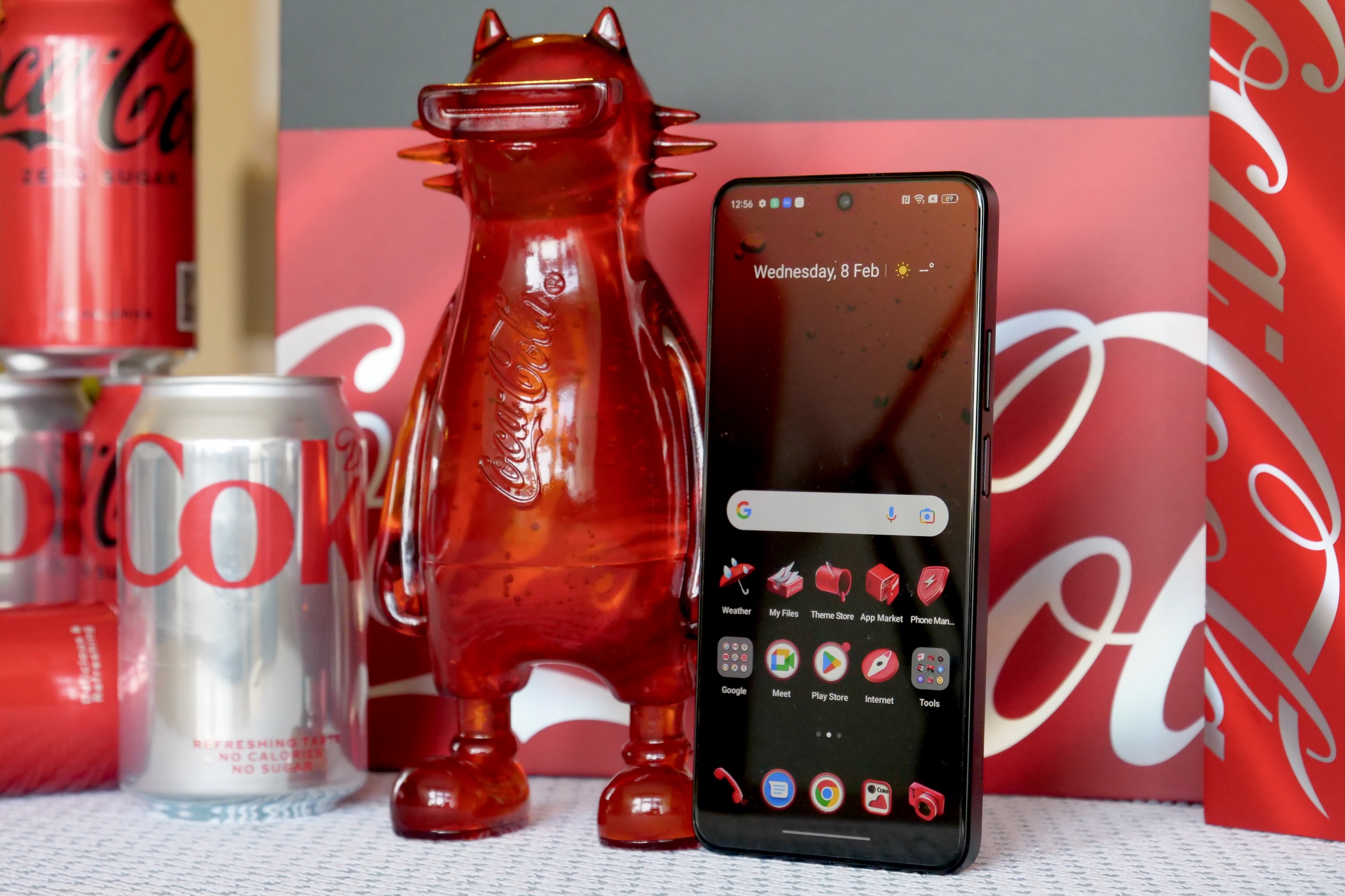 The Realme X Coca-Cola phone with the Realmeow statue.
