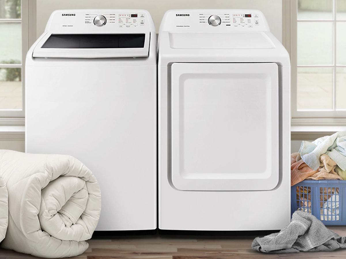 Samsung top load washer and dryer set in white in a family laundry room.