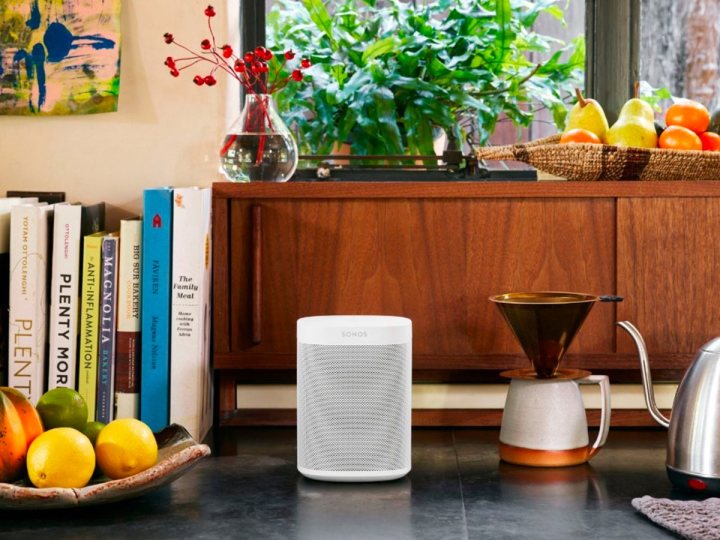 A second generation Sonos One in white on a kitchen counter.