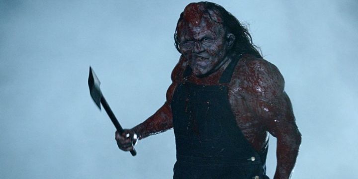 Victor Crowley stands in the fog holding his trademark hatchet.