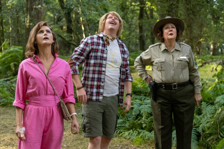 Keri Russell, Jesse Tyler Ferguson, and Margo Martindale look up in the air in a scene from Cocaine Bear.