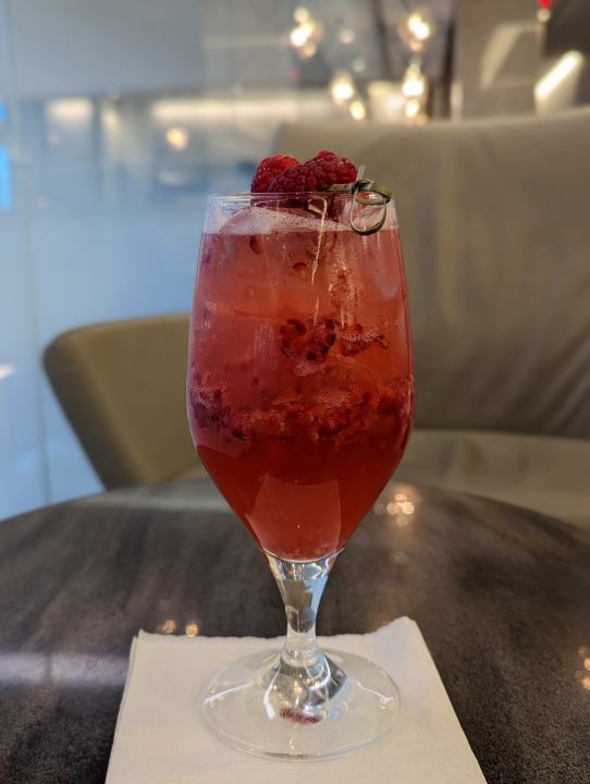 Pixel 7 Pro portrait mode photo of a raspberry drink on a table.
