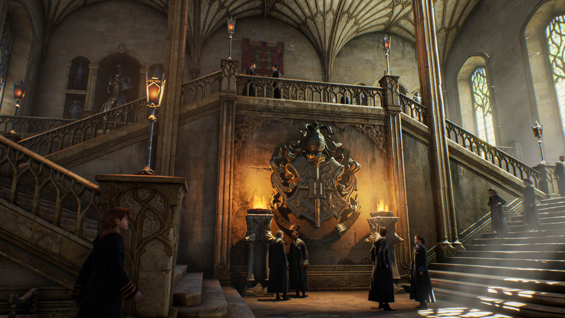 Students stand around a lobby in Hogwarts Legacy.