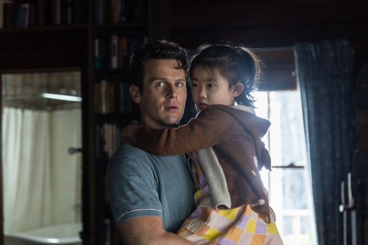 Jonathan Groff holds Kristen Cui in a scene from Knock at the Cabin.