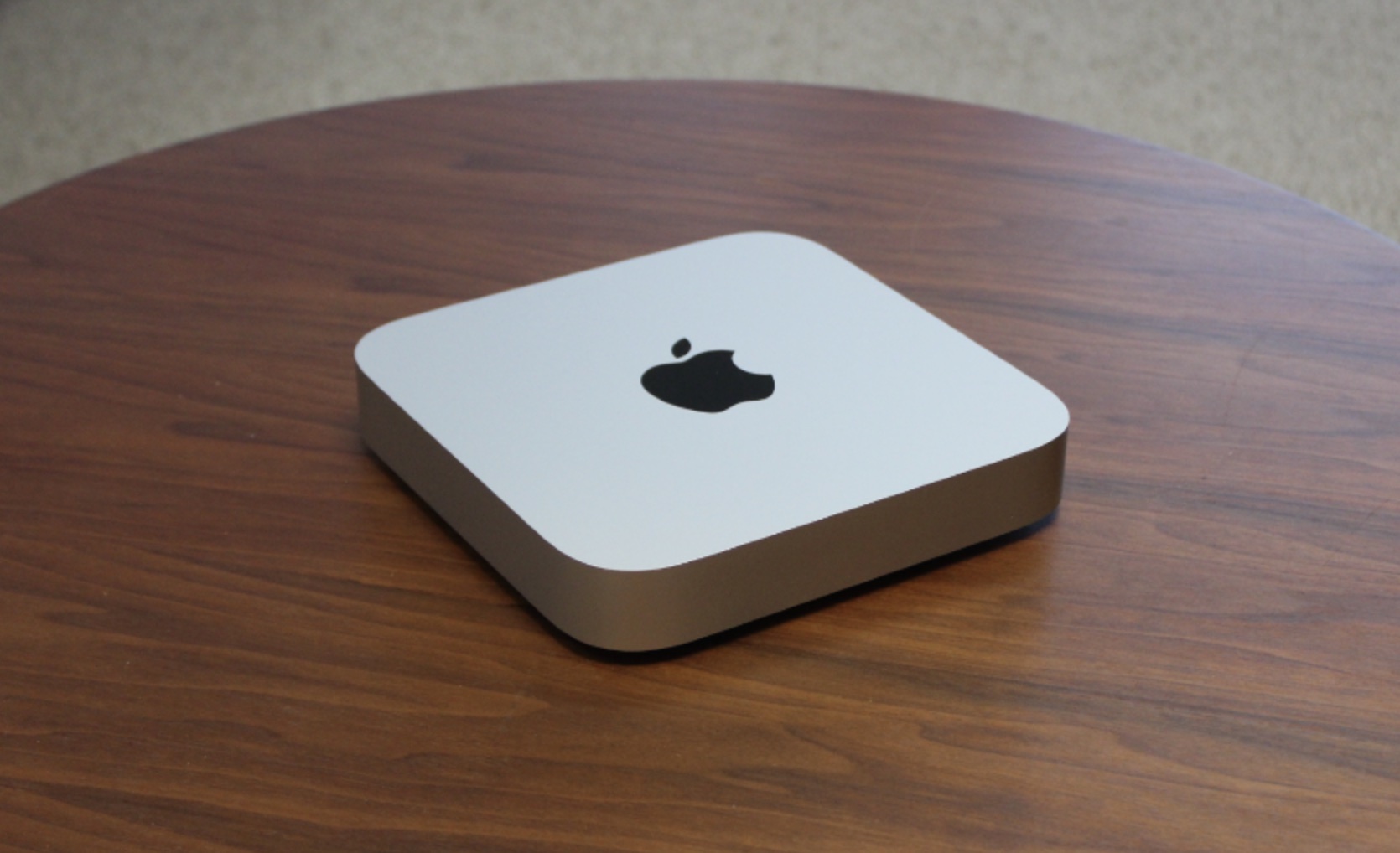 O Mac mini em uma mesa de madeira.
