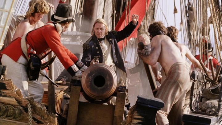 Russell Crowe sits on a cannon in Master and Commander: The Far Side of the World.