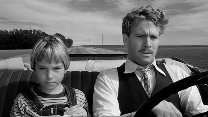 Tatum and Ryan O'Neal driving in a car in Paper Moon.