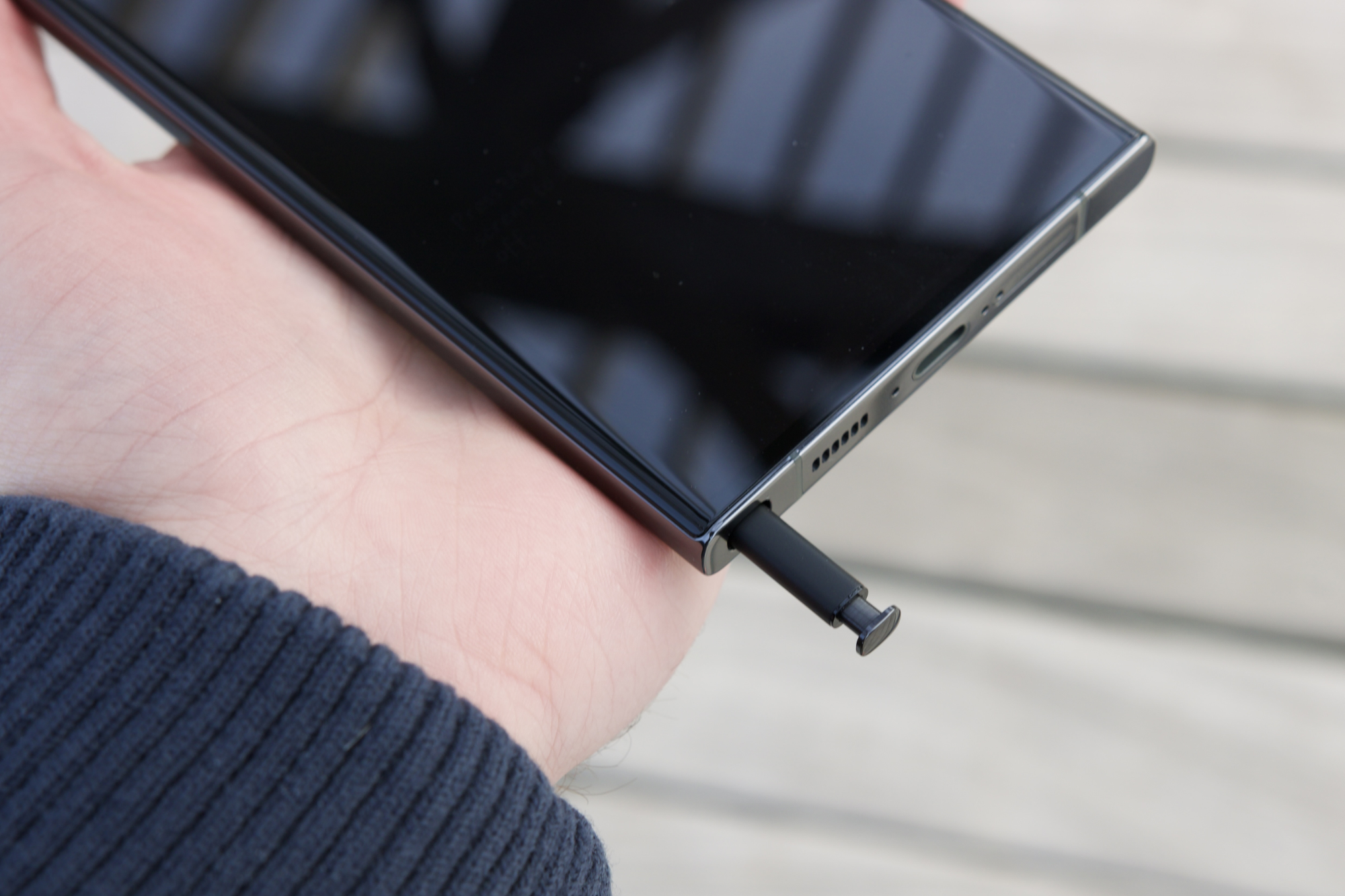 The S Pen sticking out of the bottom of the Samsung Galaxy S23 Ultra.