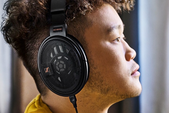 Man wearing Sennheiser HD 660S2 open-back headphones.