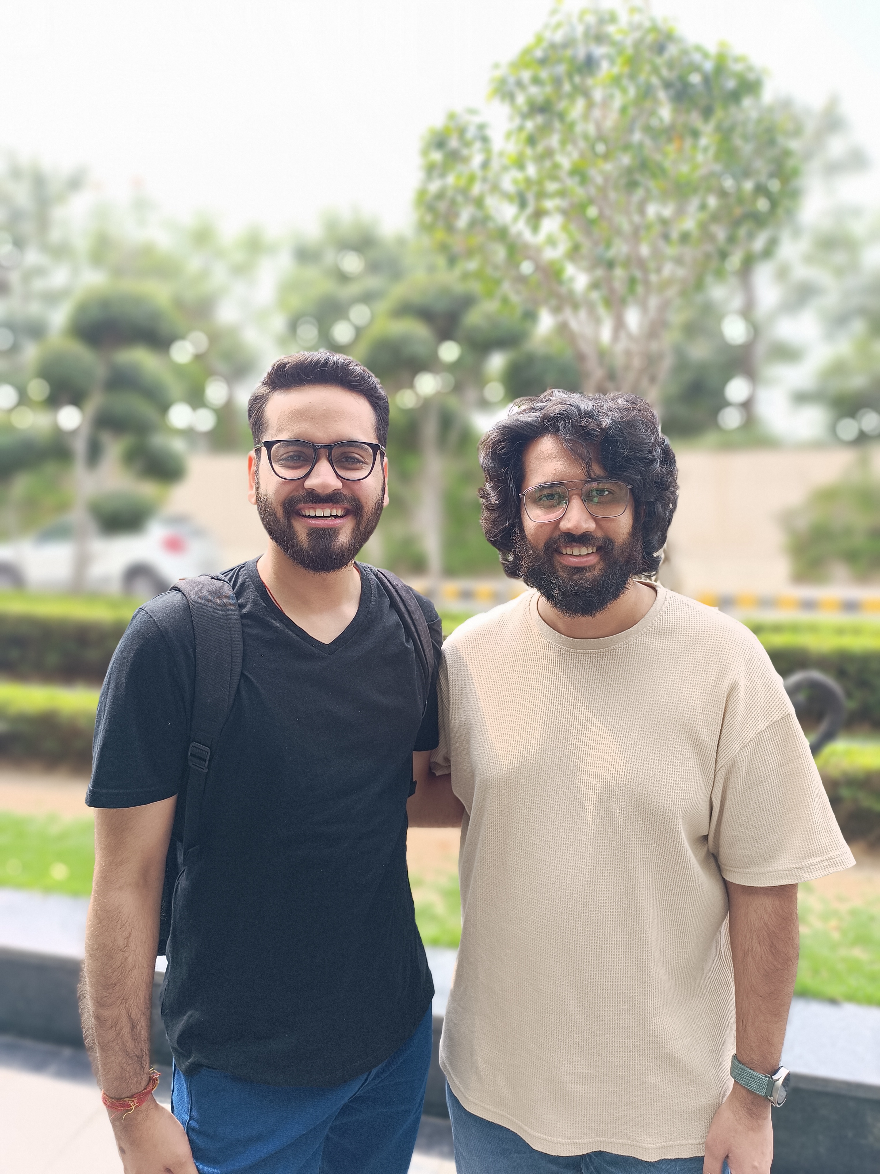 Two men standing in a hotel driveway captured by Redmi Note 12 Pro Plus.