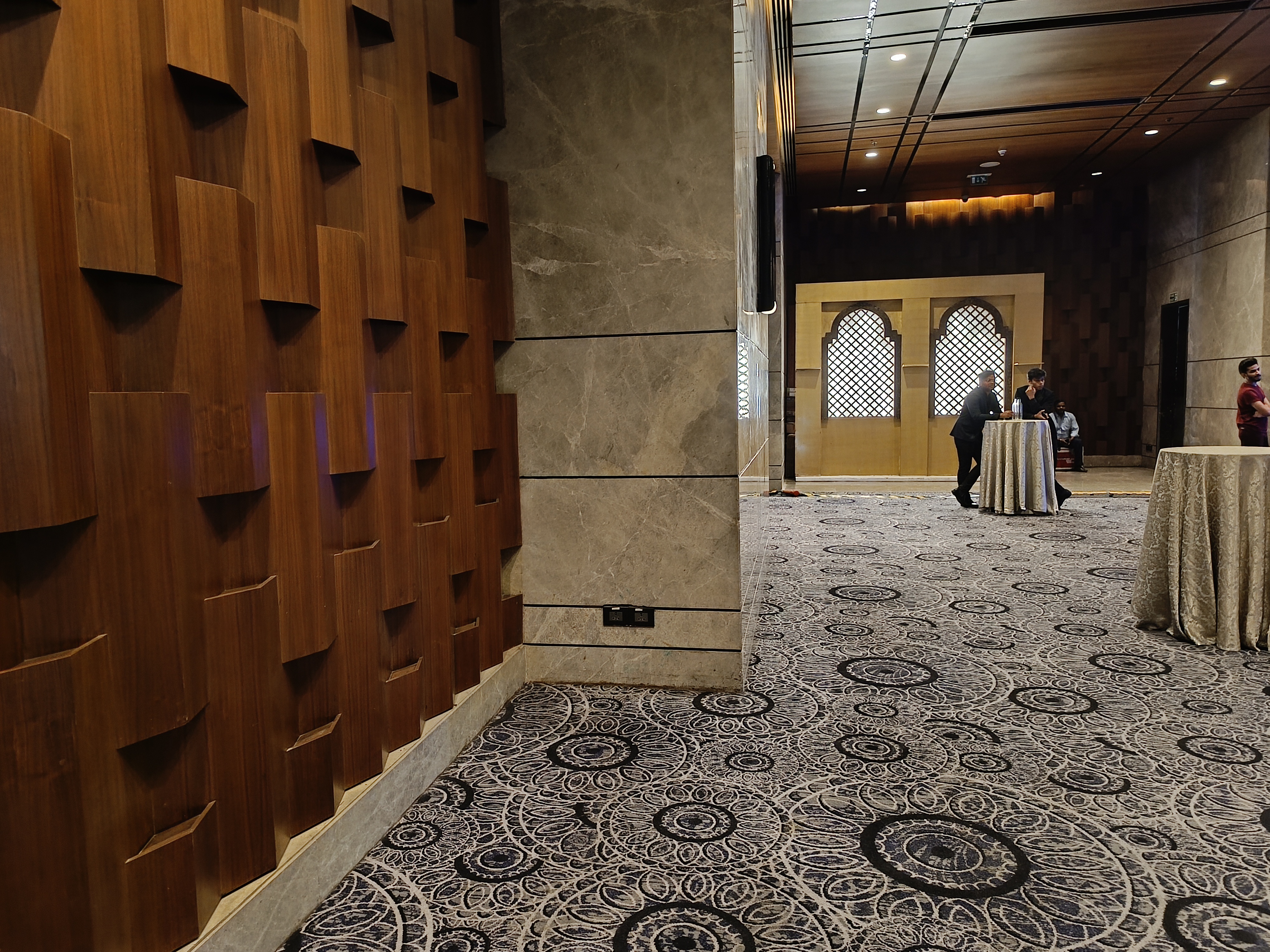 A dim lit hotel hallway captured by Redmi Note 12 Pro Plus.