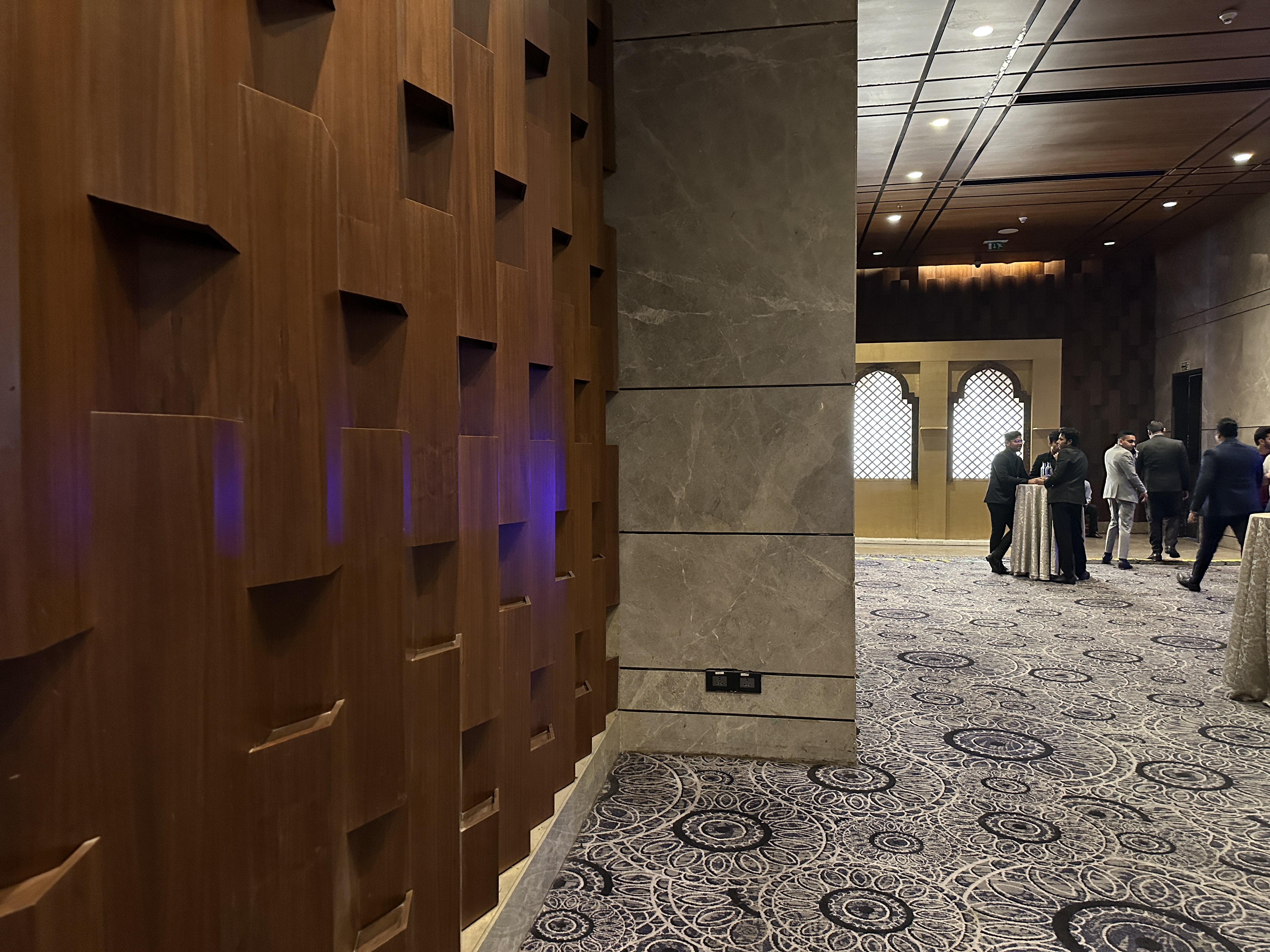A dim lit hotel hallway captured by iPhone 14 Pro.