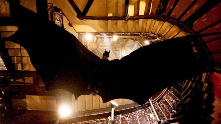 Batman gliding down a stairwell in Batman Begins.